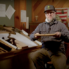 Reliance Timber team member explaining wood pieces within their shop