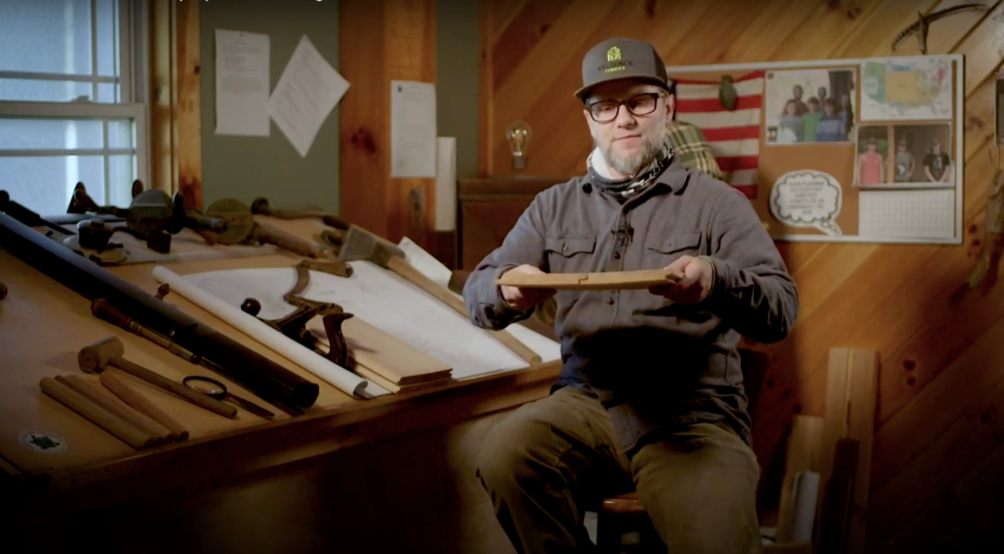 Reliance Timber team member explaining wood pieces within their shop